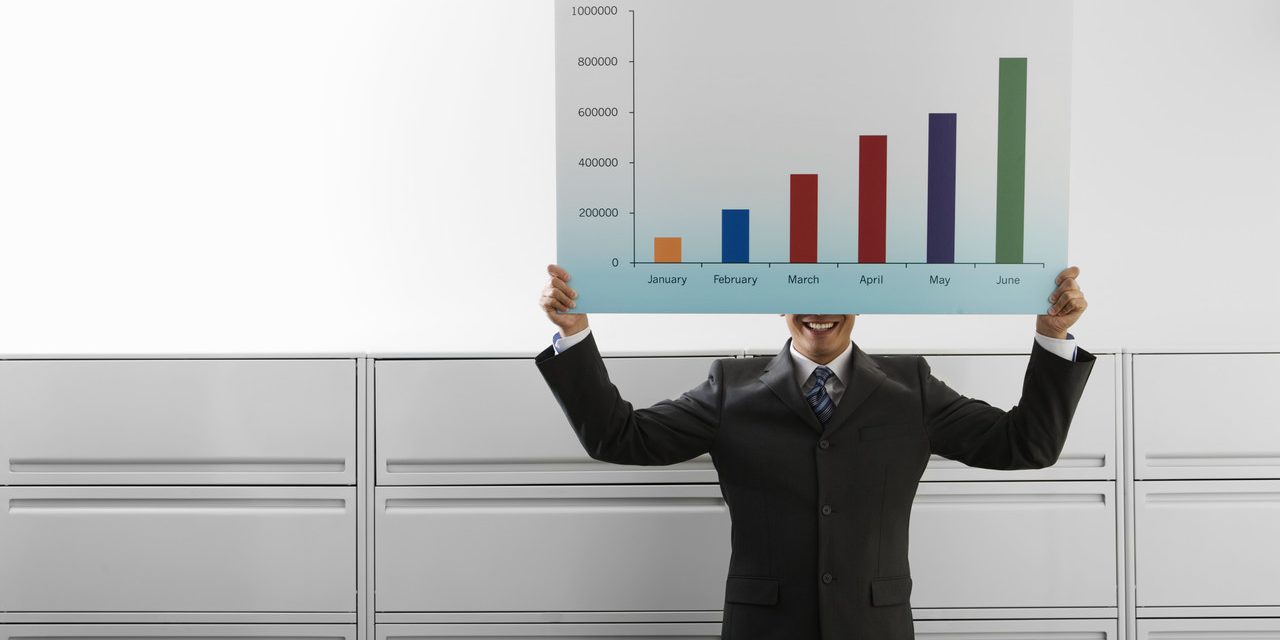 Businessman Holding Graph