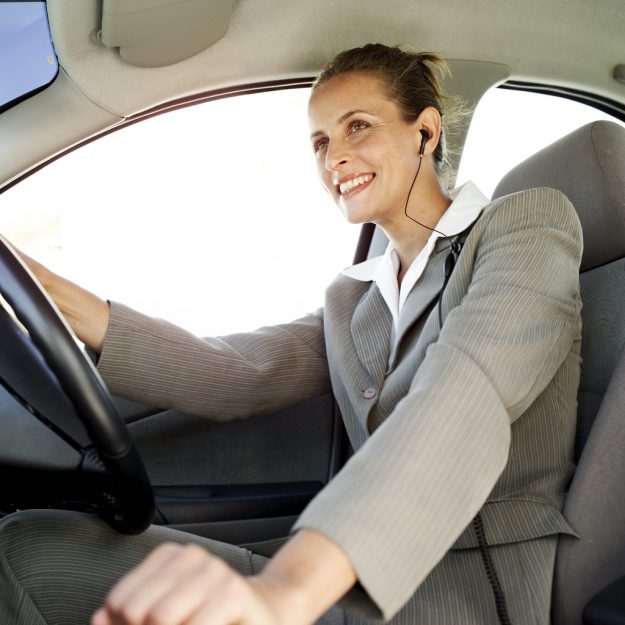 Managing the log book just got easier Woman Driving a Car and Wearing Earphones