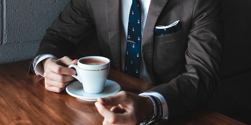 Director’s fees: What and How To Pay Them man exec suit coffee